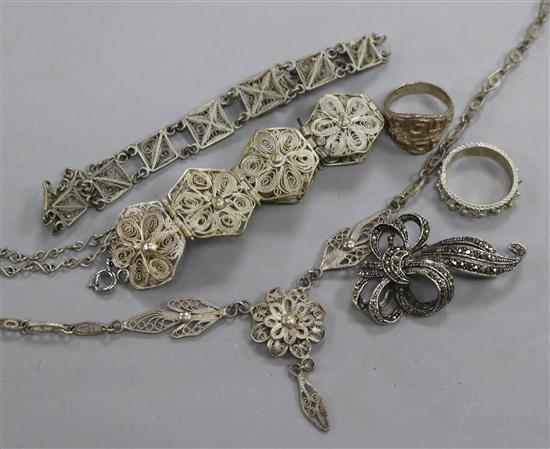 A small group of white metal filligree jewellery.